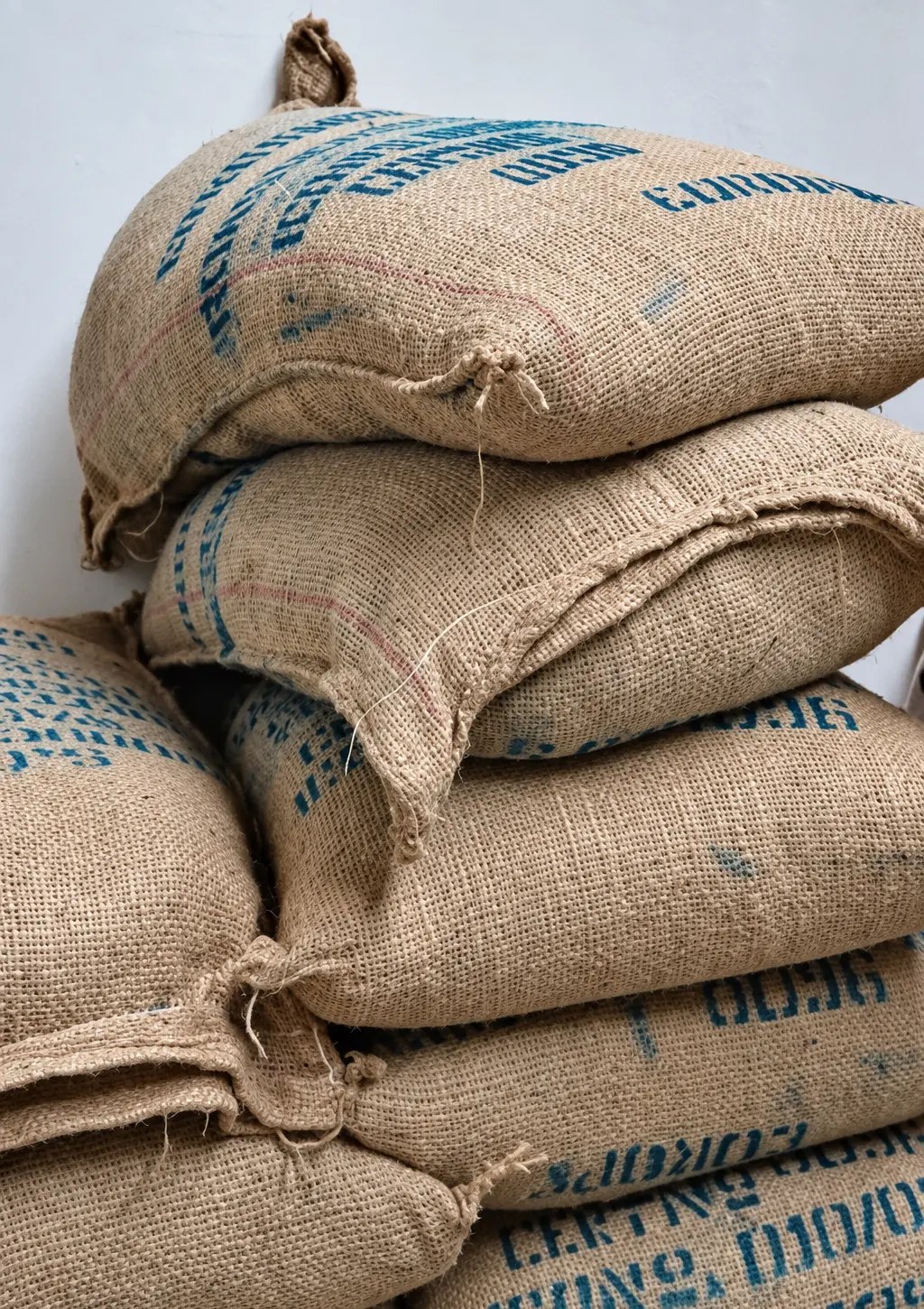 Stacked jute bags of green coffee